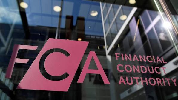 Financial Conduct Authority (FCA) sign beside a glass office entrance.