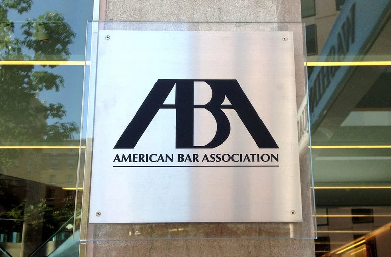 American Bar Association logo and name on a metal sign outside its office.