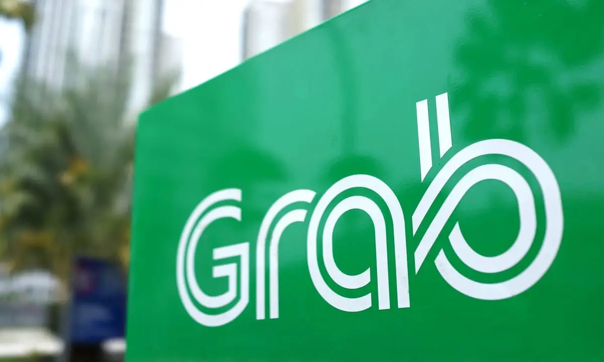 Grab logo displayed on a green company sign