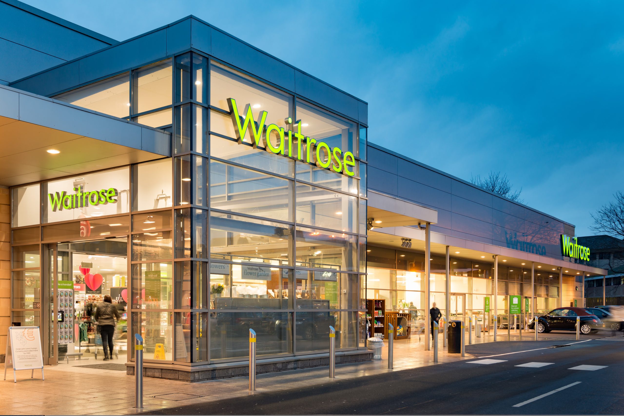 John Lewis and Waitrose stores as John Lewis Partnership reports a £124m first-half loss