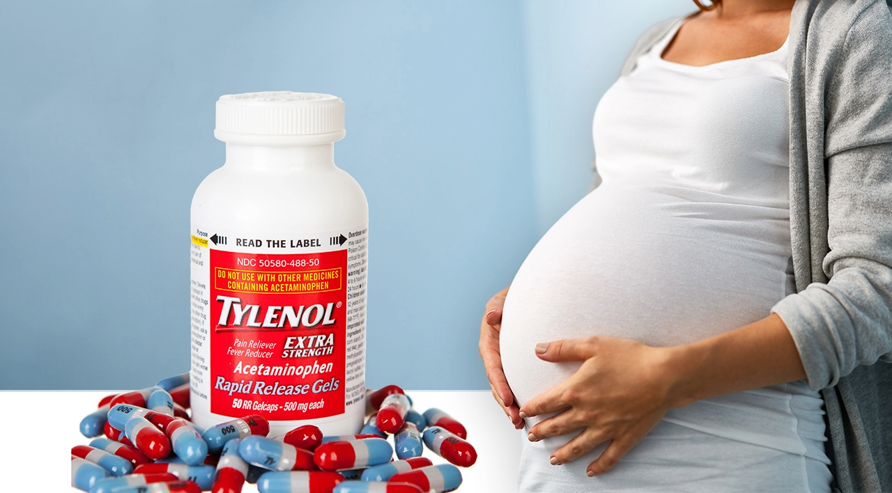 Tylenol bottle beside a pregnant woman holding her stomach