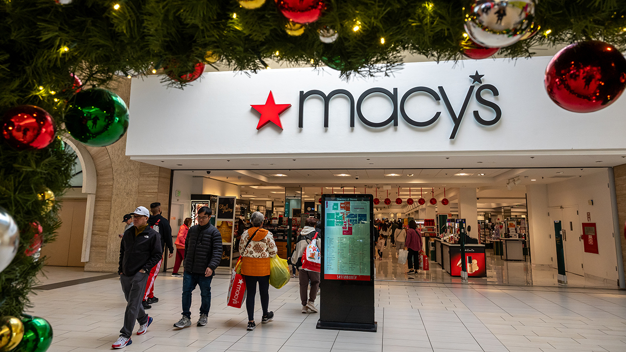 Shoppers inside a Macy’s department store as the retailer raises its 2026 sales and profit forecasts