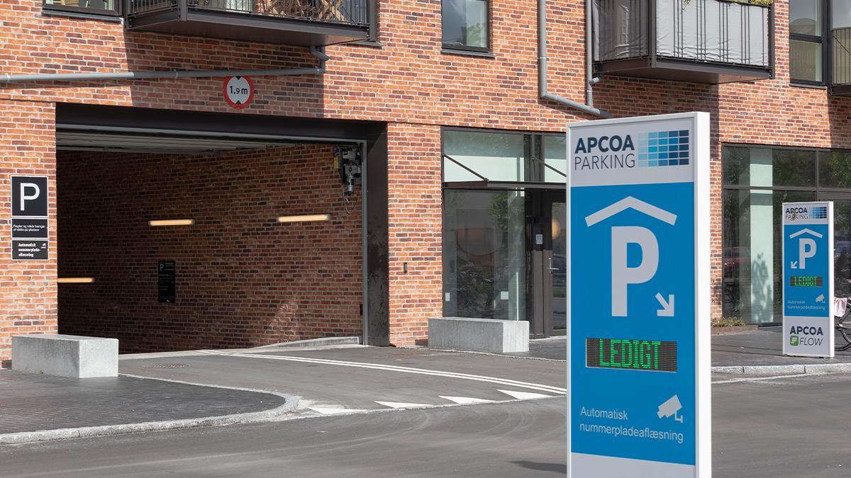 Modern parking facility with vehicles and digital parking management technology, illustrating APCOA&rsquo;s parking services.