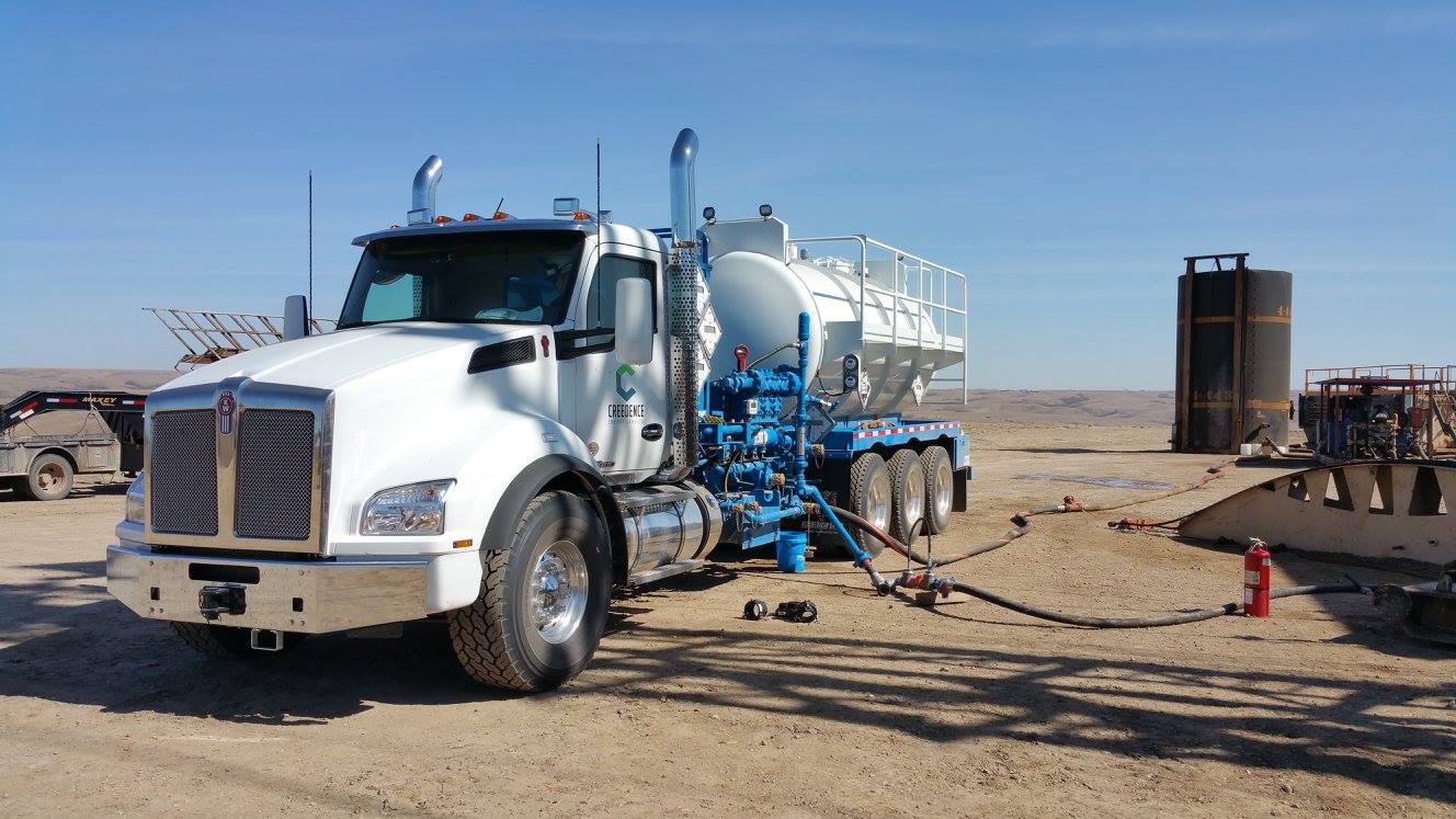 Creedence Energy Services branded oilfield chemical service truck at an oil and gas production site.