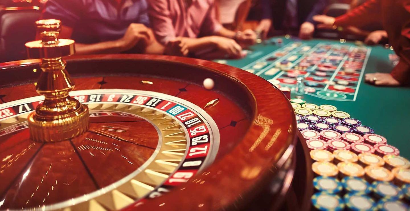 Roulette wheel and gambling chips at a casino table, illustrating the gambling industry.