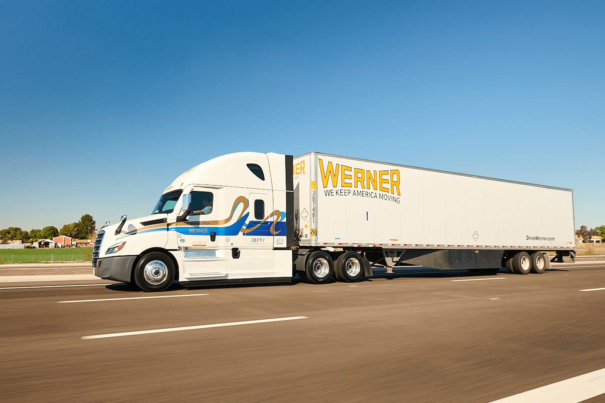 Werner Enterprises branded semi-truck travelling on a US highway.