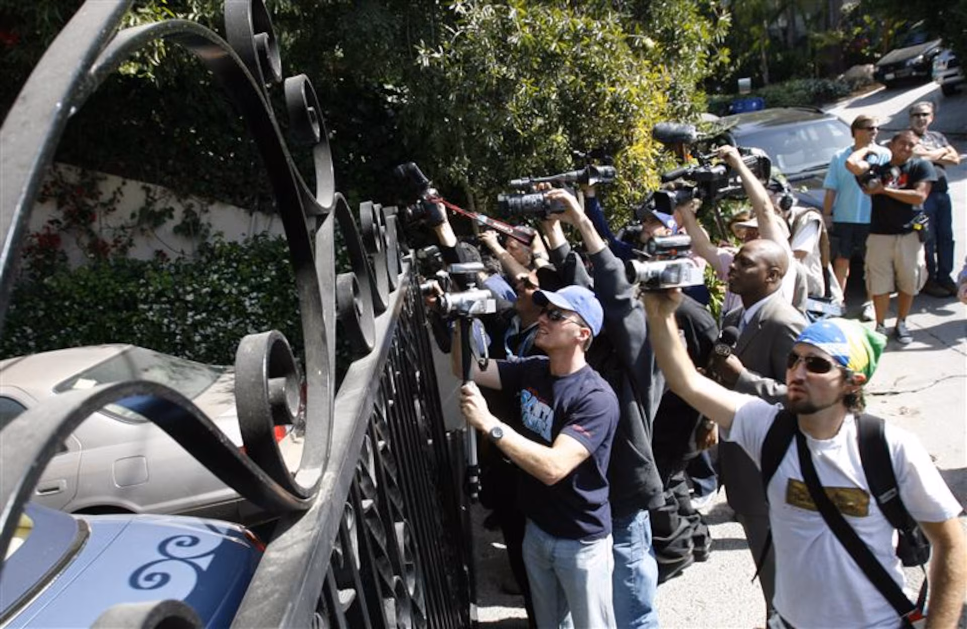 Press photographers with cameras raised, photographing an event